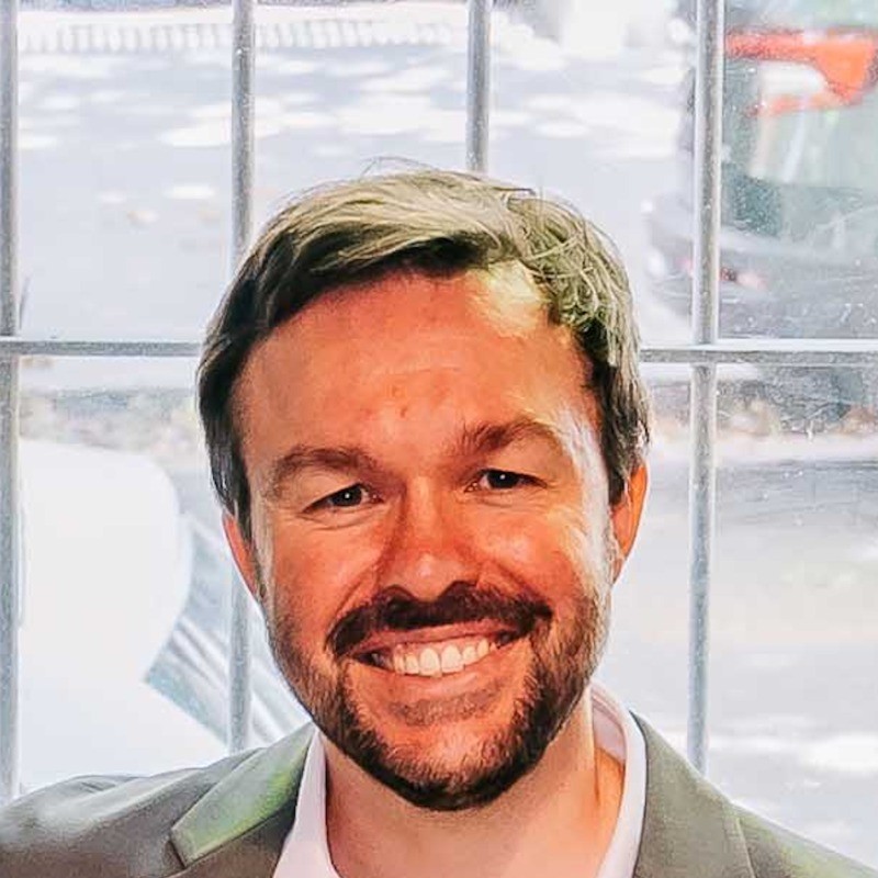 Dave, founder of Make It Land, smiling in front of a window
